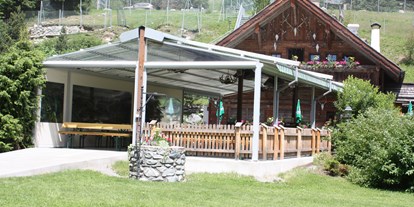 Essen-gehen - Preisniveau: €€€ - Mathon (Ischgl) - Unser Biergarten mit Überdachung und Heizung - Wildererhütte
