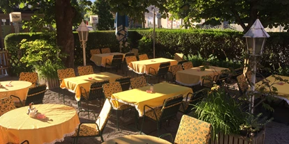 Essen-gehen - grüner Gastgarten - PLZ 6070 (Österreich) - Unser Gastgarten mit altem Kastanienbaum-Bestand lädt zum Verweilen ein und bietet  zur warmen Jahreszeit
einen ruhigen Rückzugsort im Stadtgetümmel. - Restaurant Dollinger