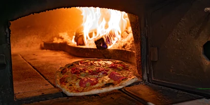 Essen-gehen - Ambiente: klassisch - ©Chrissy Kampl | My Alpenwelt Resort - Pizzeria Amore