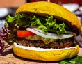 Restaurant: Veganer Black Bean Burger: Burger im Curcuma Bun mit einem Patty aus Bohnen, Soja und Linsen, abgerundet mit Cashewnüssen hausgmachter Sojamayo und Gurkenrelish - Murrerwirt in Aiterhofen